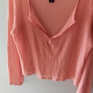Peach colored cropped sheer sweater